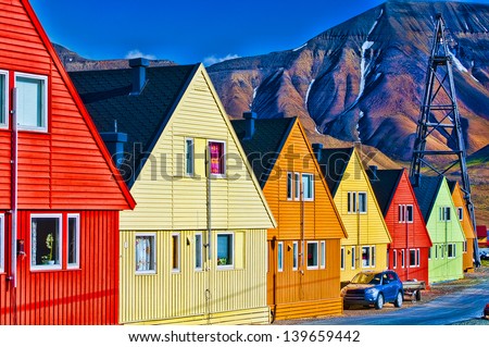 Digitally enhanced row of very colorful homes in Longyearbyen, Svalbard, Norway.