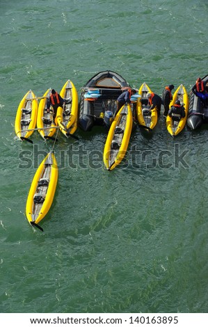 Tourists loading inflatable ocean kayaks in the Arctic Ocean, Hornsund, Norway
