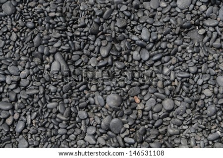 Background of smooth rounded stones on the beach, Maui, Hawaii, USA