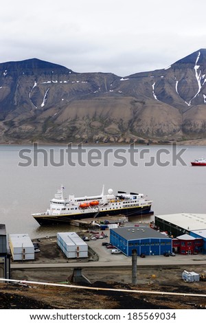 LONGYEARBYEN, SVALBARD, NORWAY - JULY 25 2010: The cruise ship National Geographic Explorer waiting to depart the Arctic bay of Adventfjorden.