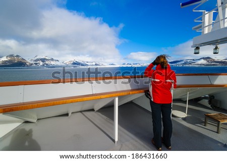 HORNSUND, SVALBARD,NORWAY - JULY 26, 2010:  Photographer on the National Geographic Explorer cruise ship in the Arctic.
