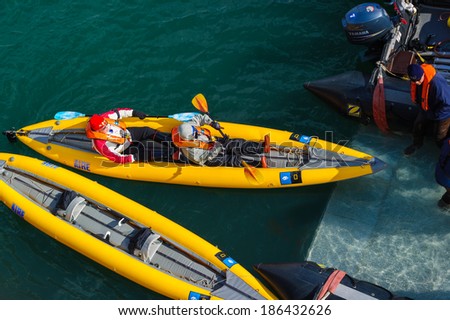 HORNSUND, SVALBARD,NORWAY - JULY 26, 2010:  Tourists getting in inflatable ocean kayaks, Hornsund, Norway