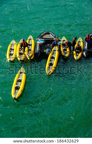 HORNSUND, SVALBARD,NORWAY - JULY 26,  2010:  Tourists loading inflatable ocean kayaks in the Arctic Ocean, Hornsund, Norway