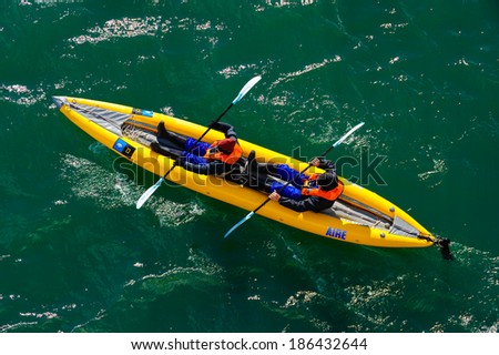 HORNSUND, SVALBARD,NORWAY - JULY 26, 2010: Tourists from the National Geographic Explorer cruise ship on inflatable kayaks in the Artic Ocean exploring a fijord in the Arctic.