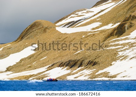 Tourists in inflatable ocean rafts in the Arctic Ocean, Hornsund, Norway.