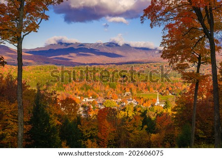 Fall foliage landscape overlooking Stowe Community Church and Stowe Village in the foreground, Stowe, Vermont, USA