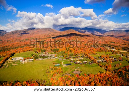 Aerial autumn view of Trapp Family Lodge and Mt. Mansfield in the background.
