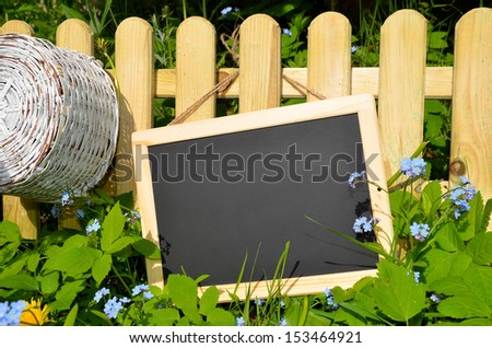 Wooden sign with flowers on fence
