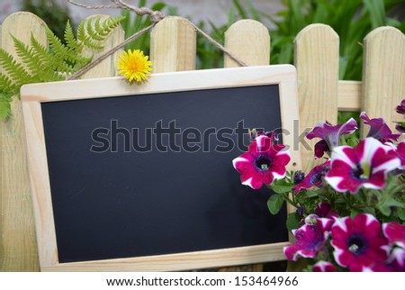 sign with flowers on fence