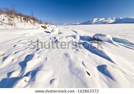 View over the frozen lake akkajaure to the akka massif, lapland, sweden
