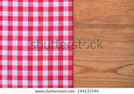 a black heart red checkered bow on wood background