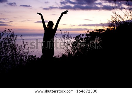 silhouette of a dancing woman in the sunset
