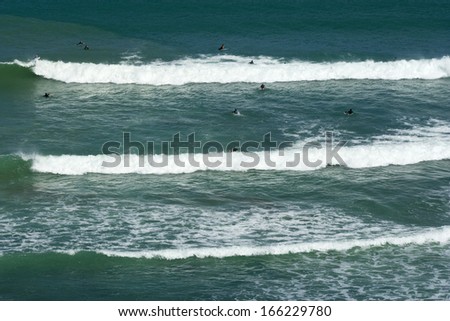 Waves, surf waves wash ashore the black sand beach of Maori Bay, Muriwai Regional Park, Auckland, North Island, New Zealand