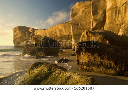 Cliff formations at Tunnel Beach, sculpted cliffs seen from Tunnel Beach in first morning light, Otago, South Island, New Zealand