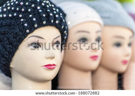 3 dolls heads side by side with knitted hats