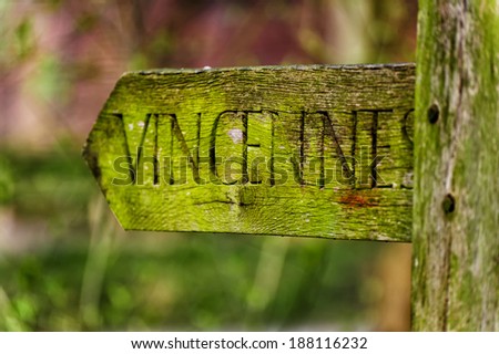 weathered sign indicating a trail