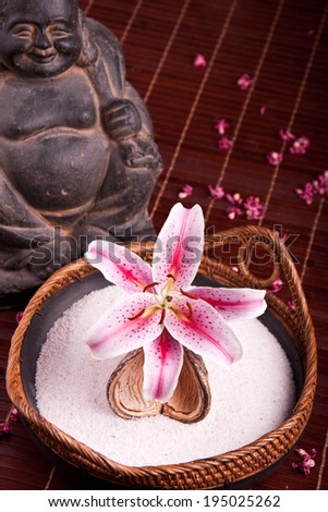 Bowl with pink lily and buddha statue