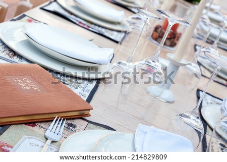 festive table with wine glasses, gold rim dishes