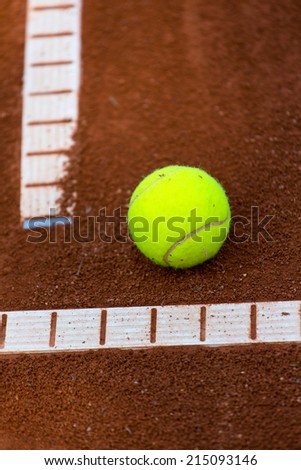 This is a Tennis-Ball on a Clay-Field