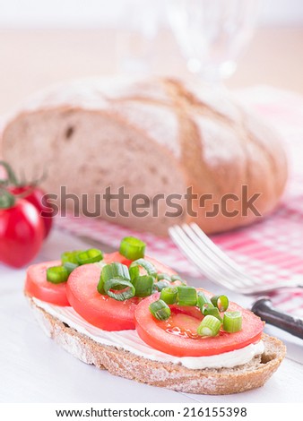 A slice of bread filled with tomato slices.