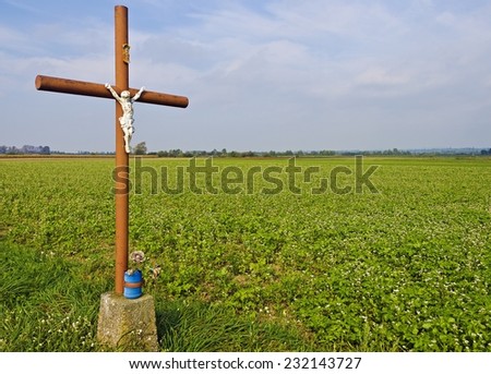 road cross with statue of Christ