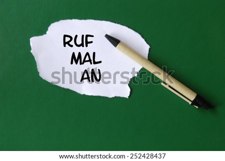pen and notice with the words: ruf mal an, translation: give me a buzz