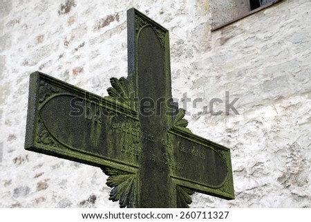 grave cross next to the church in Reelkirchen