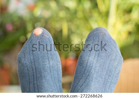 Toe looking through hole in a sock