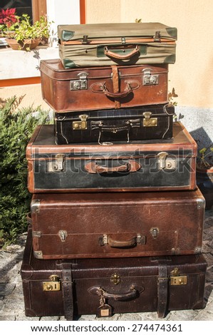 Old vintage retro used leather suitcases stacked