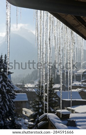 Icicles hanging down from a roof