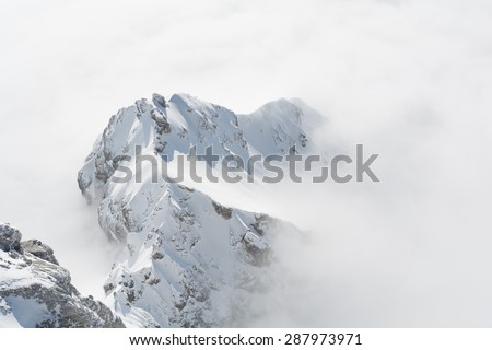 Dachstein Mountains rises above fog carpet