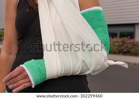 Woman with broken arm supported