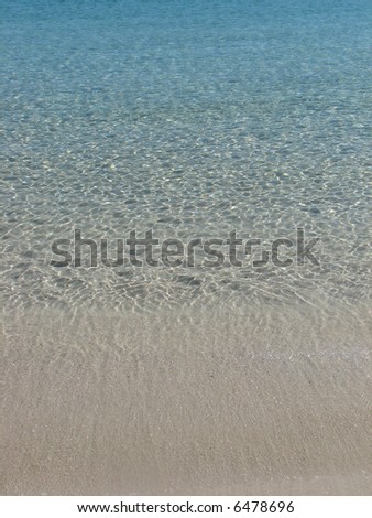 shallow azure water of a peaceful ocean bay at a calm sunny afternoon