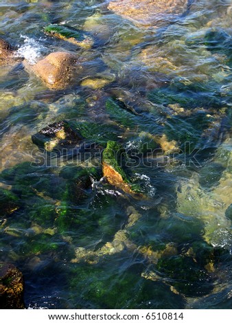smooth moss-covered stone overflown by clear water