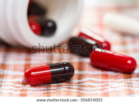 medicine capsule on check fabric