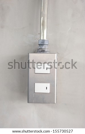 light switches on cement wall