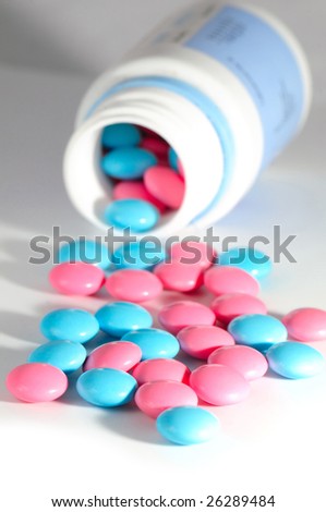 red and blue pills on white background. Macro