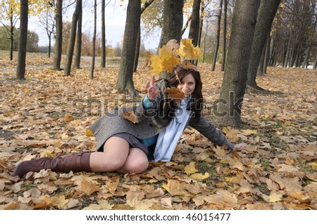 The young woman on walk in autumn park