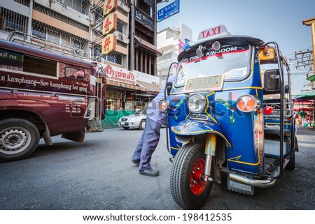 CHIANG MAI, THAILAND- January 17 : Tuk Tuk is parking on the street with unidentified driver in the market in Chiang Mai in Thailand on 17 January 2013