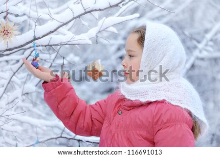 girl in profile. Winter nature and a lot of snow. On the baby shawl. Christmas spirit