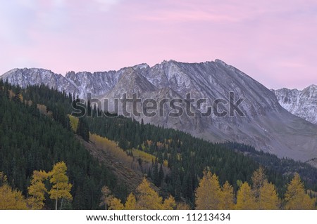 Rocky Mountains in autumn near Aspen, Colorado, USA at dawn with aspens and conifers