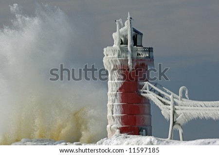 Winter, South Haven, Michigan lighthouse, Lake Michigan, with splashing wave, USA