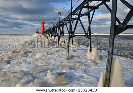 Grand Haven Lighthouse, Lake Michigan, winter, with iced pier and catwalk, Michigan, USA