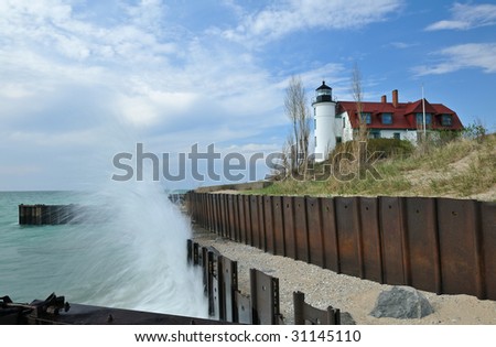 Point Betsie Lighthouse with splashing wave, Lake Michigan, Michigan, USA