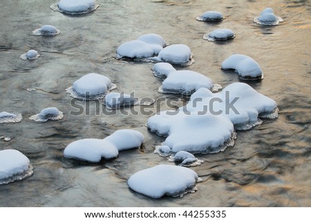 Winter landscape of snow covered rocks, Battle Creek River, Michigan, USA