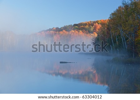Autumn landscape at sunrise of Council Lake in fog, Michigan\'s Upper Peninsula, USA