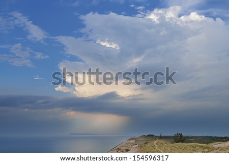 Landscape near sunset of sand dune, sunbeams and waters of Lake Michigan, Sleeping Bear Dunes National Lakeshore, Michigan, USA