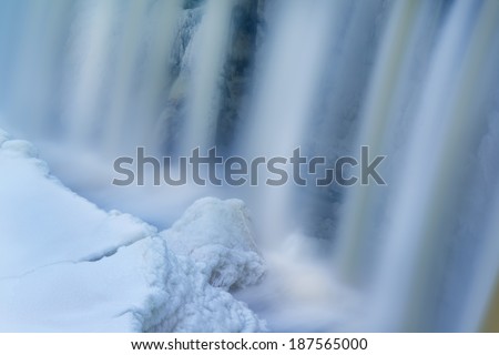 Winter, Upper Tahquamenon Falls framed by ice and captured with motion blur, Michigan\'s Upper Peninsula, USA