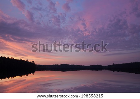 Sunrise Pete\'s Lake with beautiful reflections in calm water, Michigan\'s Upper Peninsula, USA