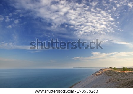 Landscape at sunrise of sand dune, clouds, and waters of Lake Michigan, Sleeping Bear Dunes National Lakeshore, Michigan, USA